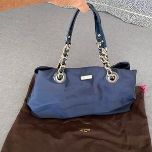 Kate Spade navy nylon at / gold chain handles.